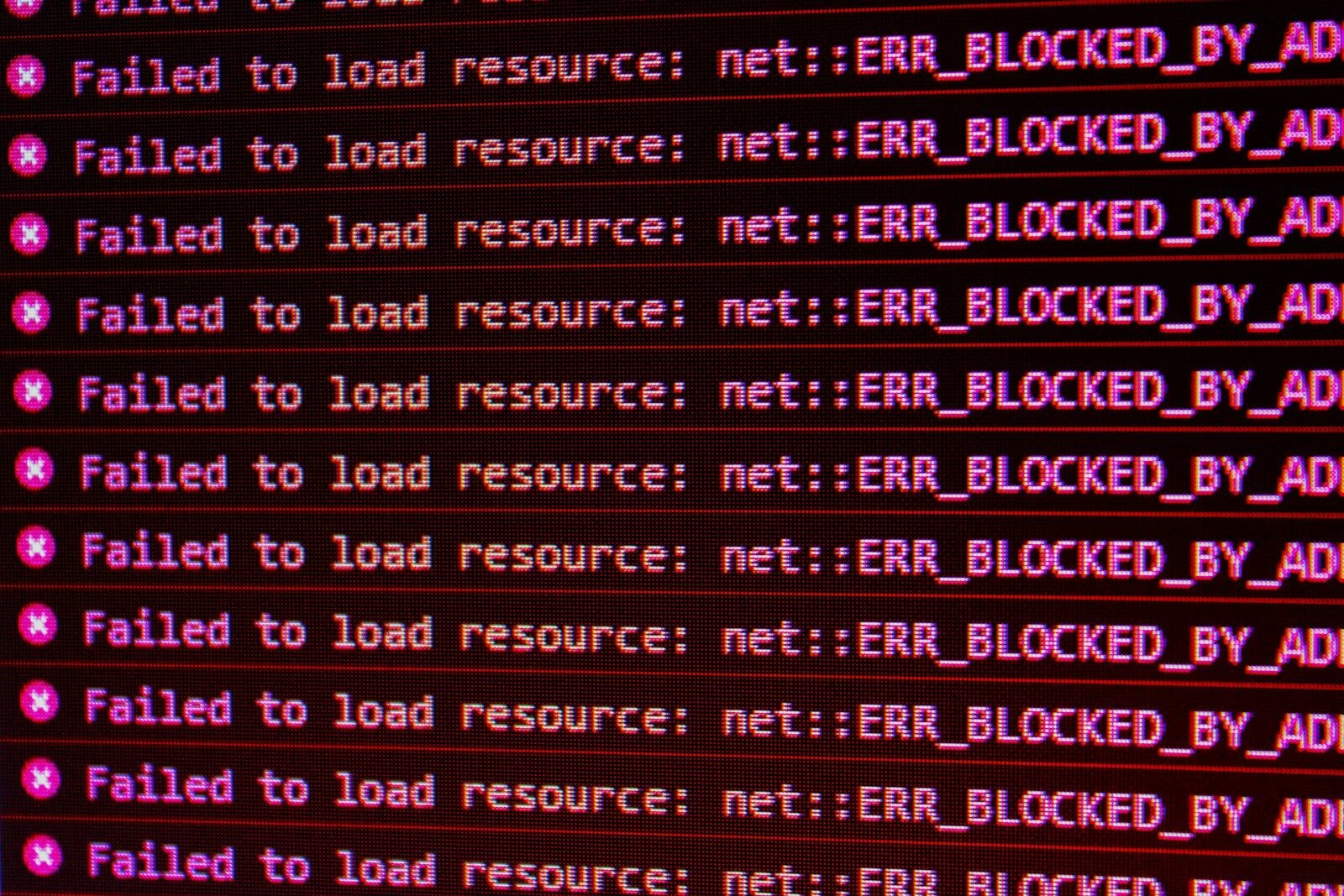 Red error messages on a black computer screen indicating blocked web resources